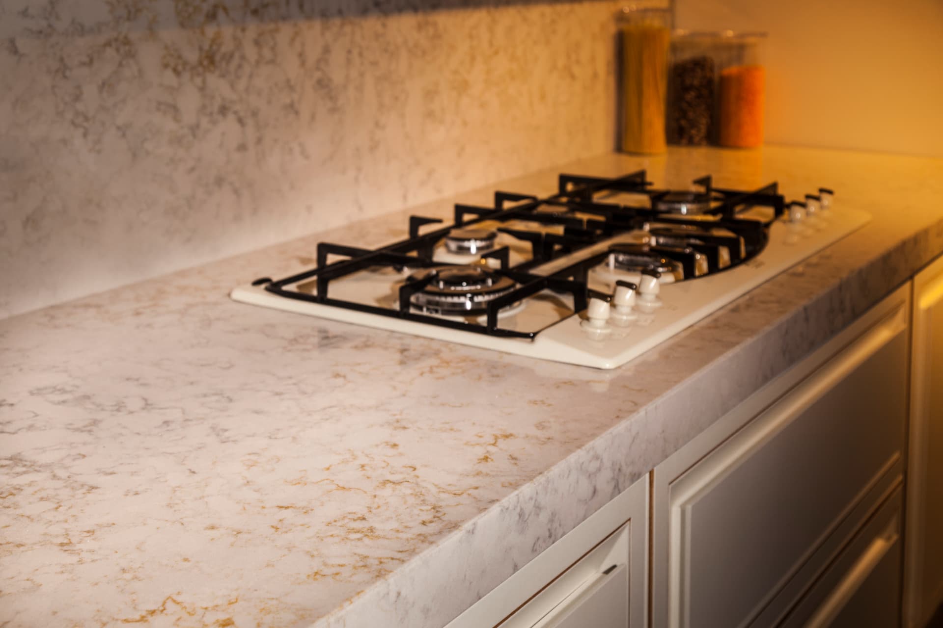 Quartz countertop edge beside an inset hob
