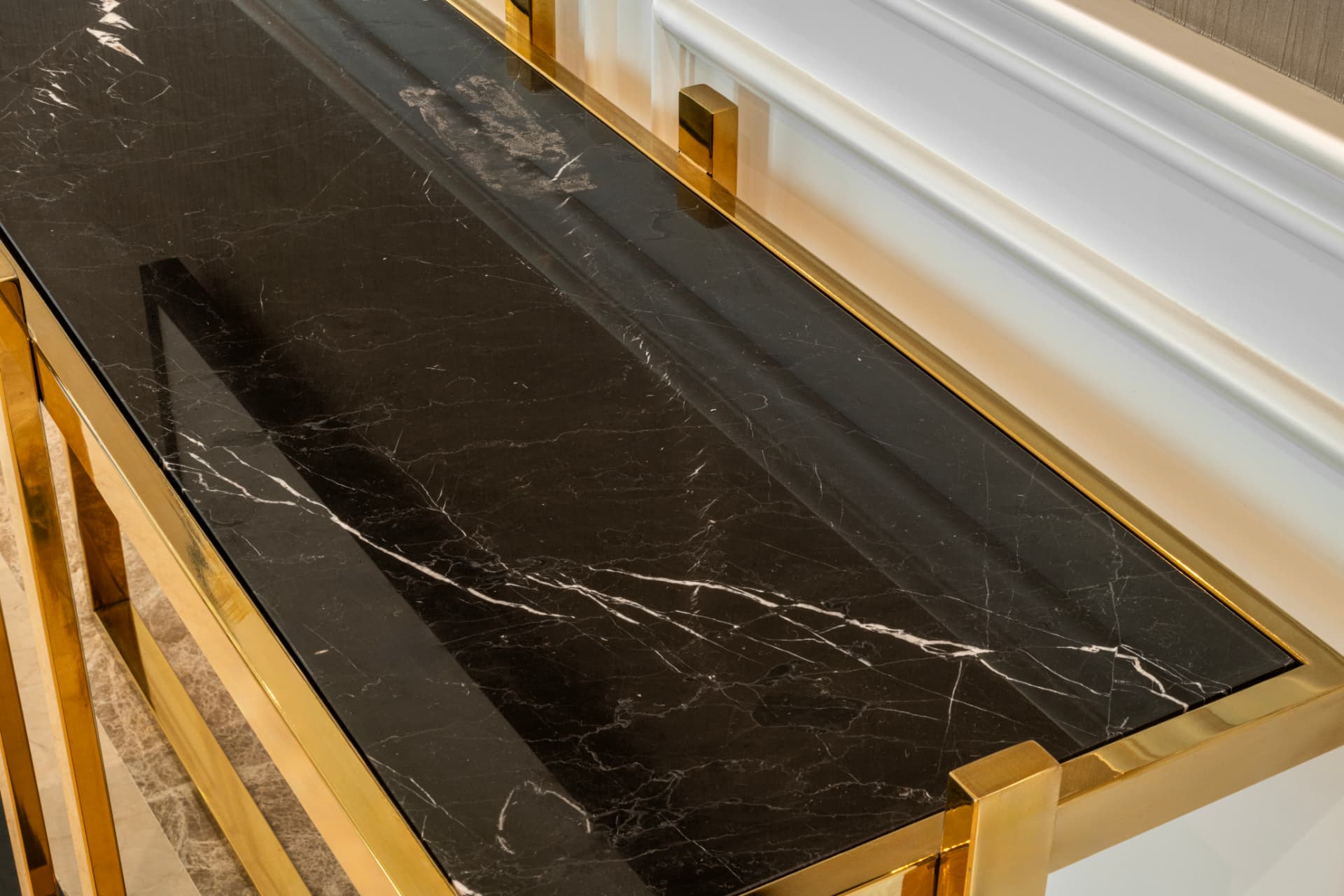Installed black marble surface with white veining and a gold frame